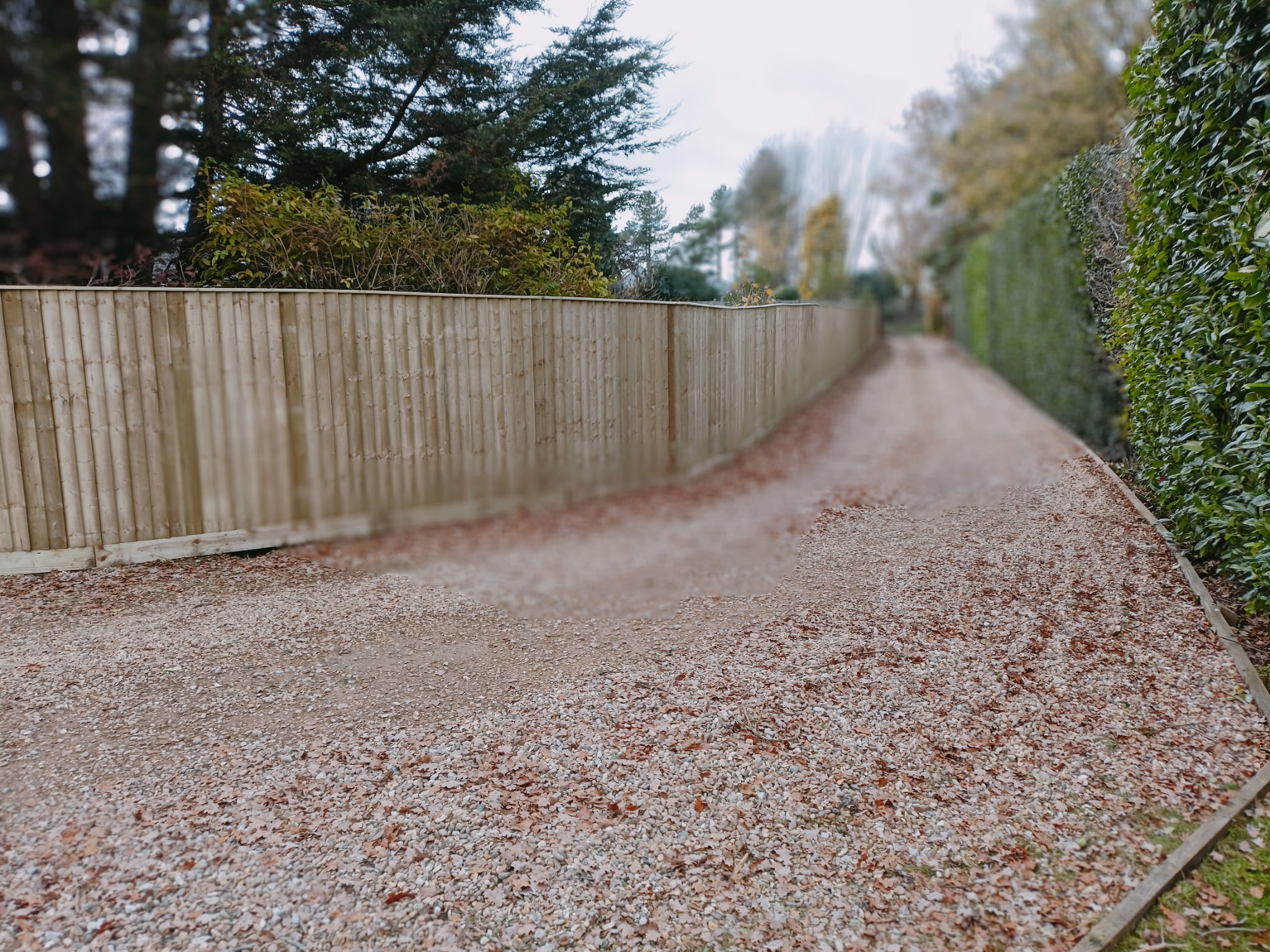 Gravel driveway with wooden fencing